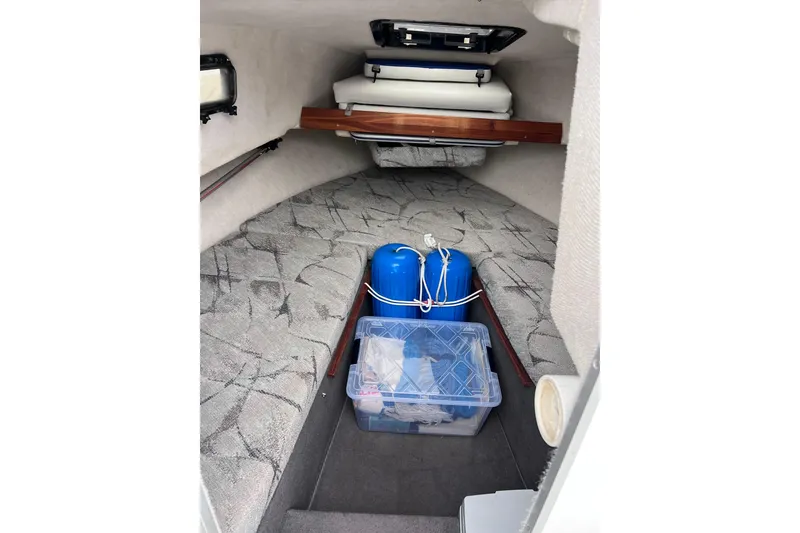 Slide: The Image of Interior cabin of 1993 Bayliner Trophy Walkaround with storage and cushions. - 19