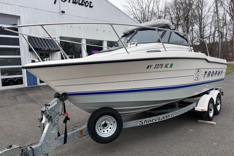 Slide: The Image of 1993 Bayliner Trophy Walkaround boat on trailer outside dealership. - 2
