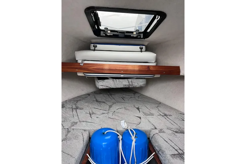 Slide: The Image of Interior cabin of 1993 Bayliner Trophy Walkaround with cushions and blue fenders. - 22