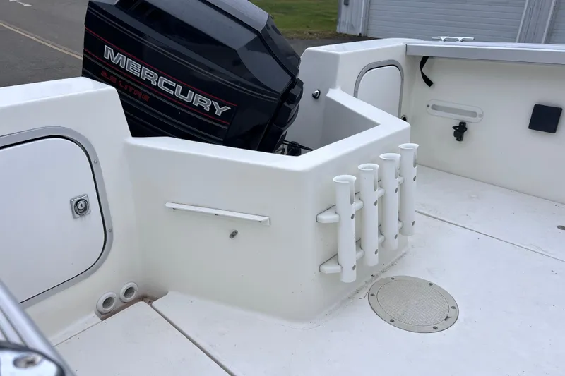 Slide: The Image of 1993 Bayliner Trophy Walkaround boat with Mercury engine and rod holders. - 24