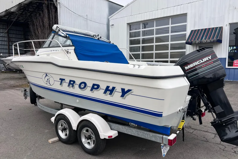 Slide: The Image of 1993 Bayliner Trophy Walkaround boat with Mercury outboard motor on a trailer. - 4