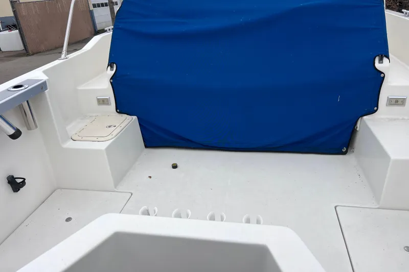 Slide: The Image of 1993 Bayliner Trophy Walkaround boat interior with blue cover and white deck. - 8