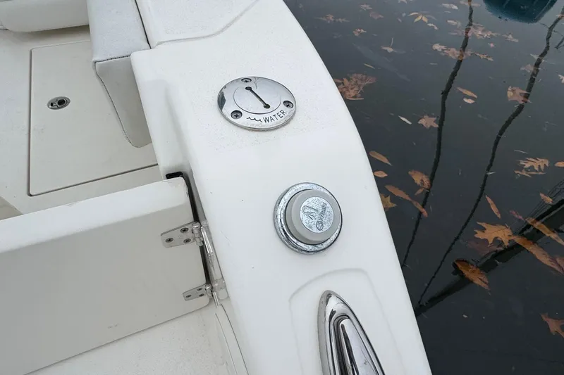 Slide: The Image of 2024 Cobia 240 Dual Console boat deck with water access and fittings. - 30