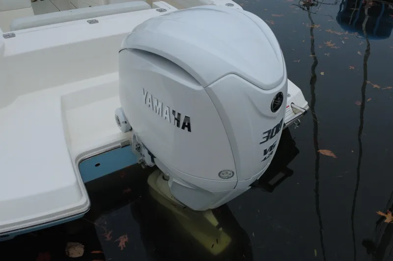 Slide: The Image of 2024 Cobia 240 Dual Console with Yamaha outboard engine on water. - 7