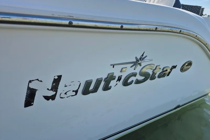 Slide: The Image of 2013 NauticStar 2000XS Offshore boat logo on white hull. - 14