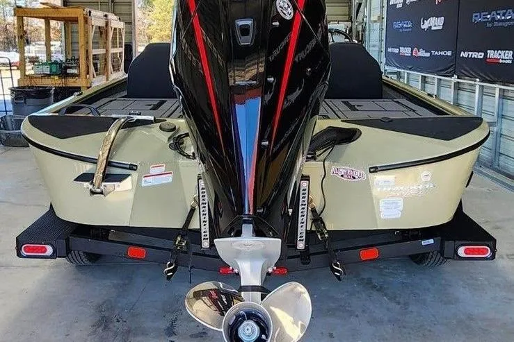 Slide: The Image of 2026 Tracker Savage 215 boat with powerful outboard motor in a garage setting. - 3