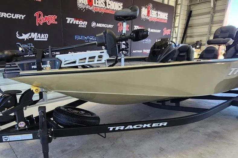 Slide: The Image of 2026 Tracker Savage 215 boat on trailer in showroom setting. - 5