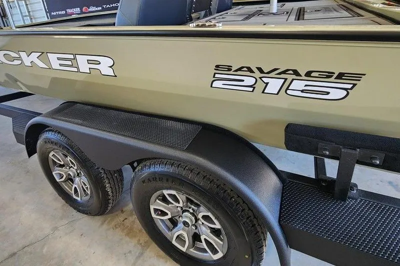 Slide: The Image of 2026 Tracker Savage 215 boat on trailer, showcasing sleek design and durable wheels. - 6