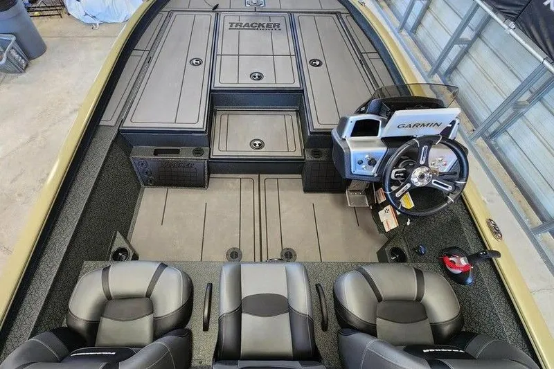 Slide: The Image of 2026 Tracker Savage 215 boat interior with Garmin navigation and dual seating. - 7