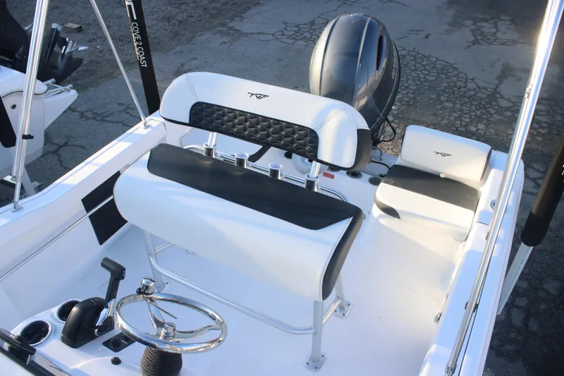 Slide: The Image of 2026 Tidewater 180 CC Adventure boat interior with steering wheel and seating. - 11