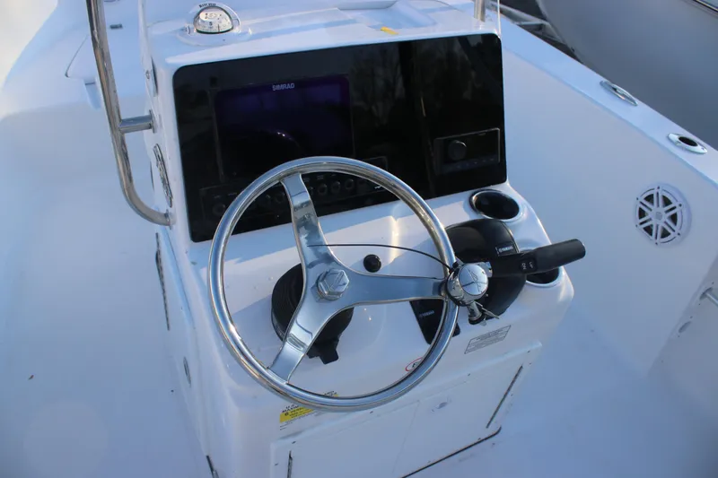 Slide: The Image of 2026 Tidewater 180 CC Adventure boat helm with steering wheel and controls. - 12