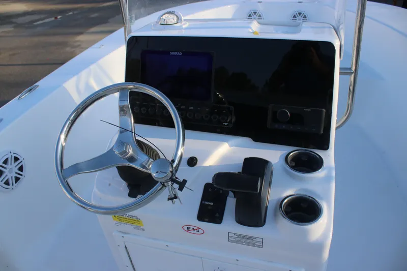 Slide: The Image of 2026 Tidewater 180 CC Adventure boat console with steering wheel and controls. - 13