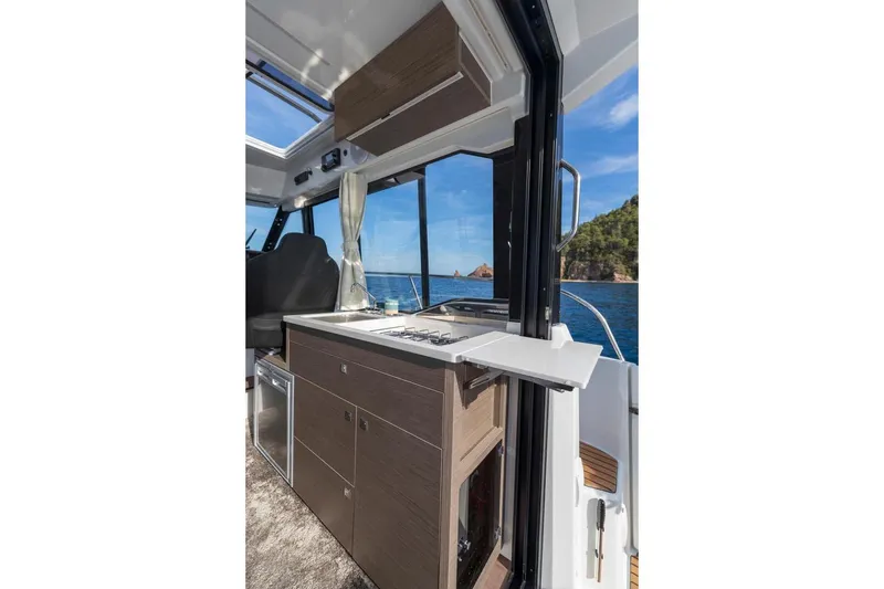 Slide: The Image of Manufacturer Provided Image: Interior view of 2025 Jeanneau NC 895 Series 2 boat with ocean backdrop. - 6