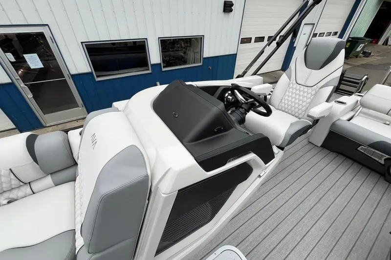 Slide: The Image of 2026 Avalon Catalina Versatile Rear Bench boat interior with modern seating and steering console. - 13