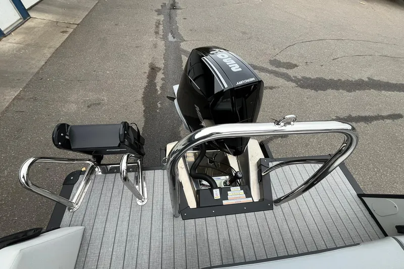 Slide: The Image of 2026 Avalon Catalina Versatile Rear Bench with Mercury outboard motor, docked on pavement. - 16