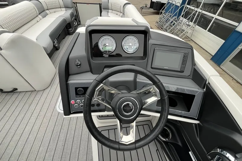 Slide: The Image of 2026 Avalon Catalina Versatile Rear Bench boat dashboard with steering wheel and gauges. - 22