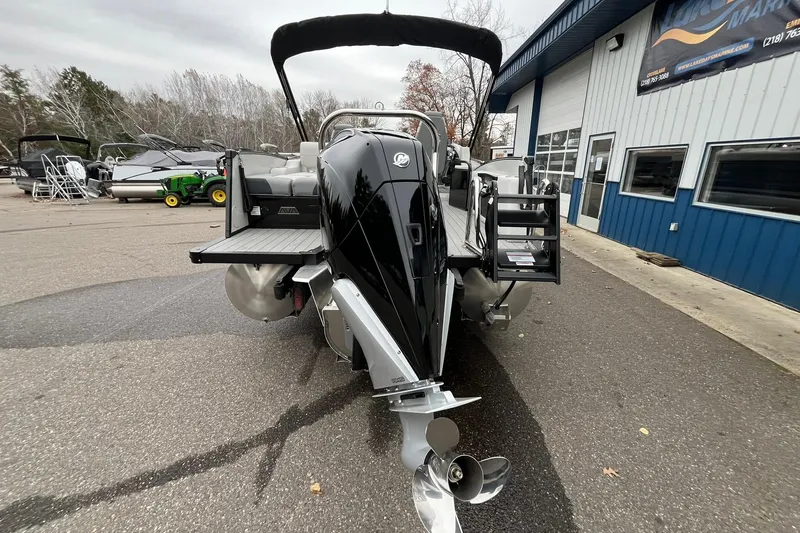 Slide: The Image of 2026 Avalon Catalina Versatile Rear Bench boat at a marina, showcasing sleek design and modern features. - 3