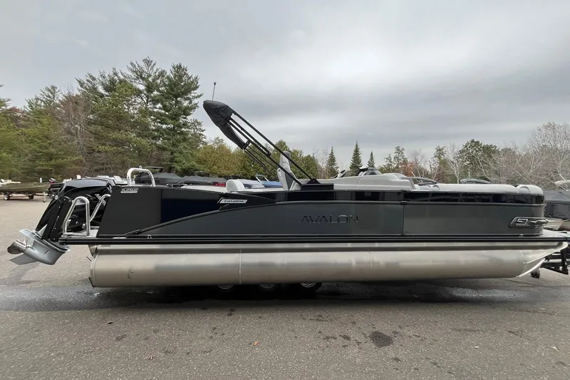 Slide: The Image of 2026 Avalon Catalina Versatile Rear Bench pontoon boat in a scenic outdoor setting. - 5