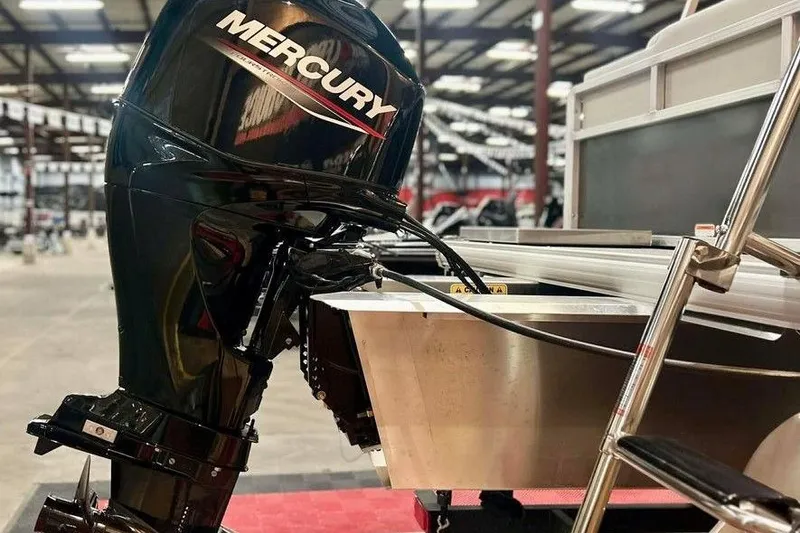 Slide: The Image of 2026 Sun Tracker Bass Buggy 16 XL Select with Mercury outboard motor in a showroom. - 5