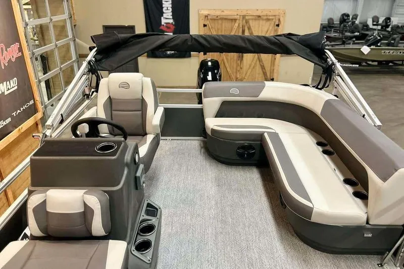 Slide: The Image of 2026 Sun Tracker Bass Buggy 16 XL Select pontoon boat interior with seating and steering console. - 7