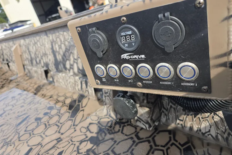 Slide: The Image of Control panel of 2026 Pro-Drive 1854 boat with camouflage design and voltage display. - 11