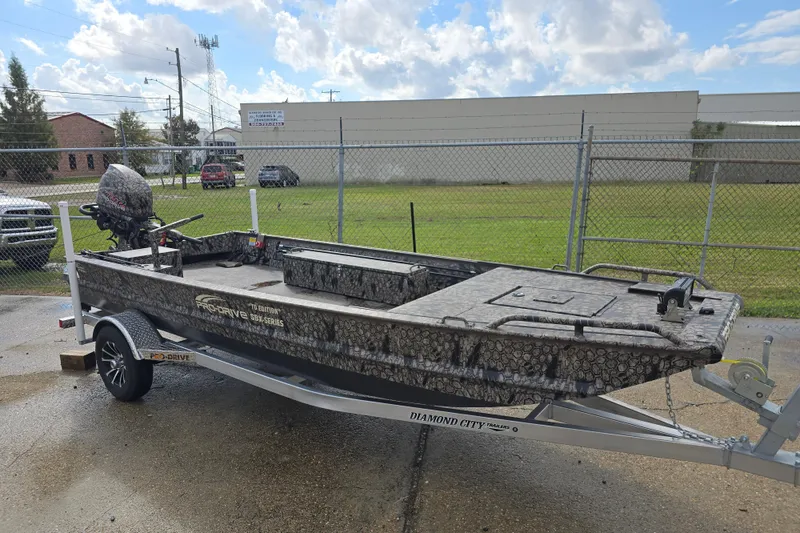 Slide: The Image of 2026 Pro-Drive 1854 boat on trailer, camo design, parked outdoors. - 4