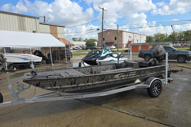 Slide: The Image of 2026 Pro-Drive 1854 boat on trailer, parked outdoors near industrial buildings. - 6