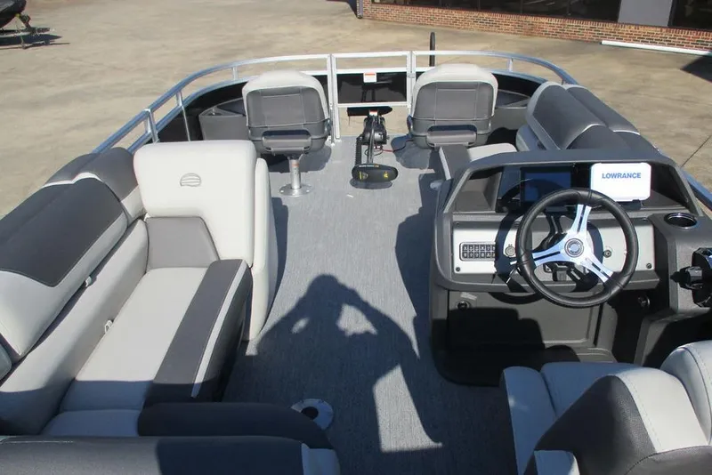 Slide: The Image of 2026 Sun Tracker Fishin' Barge 20 DLX interior with seating and steering console. - 3