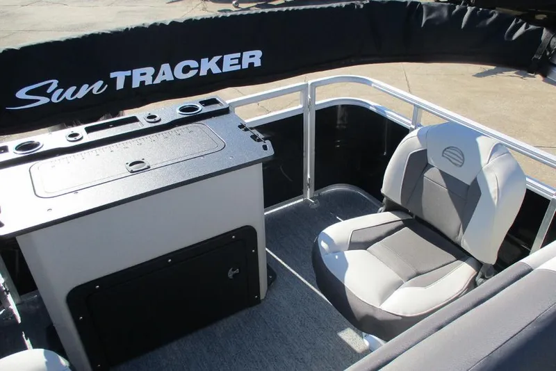 Slide: The Image of 2026 Sun Tracker Fishin' Barge 20 DLX interior with seating and console. - 5