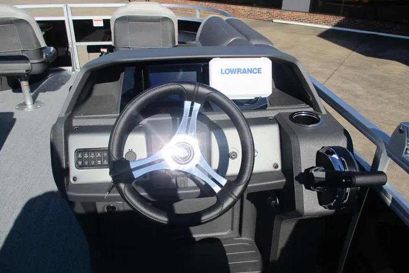 Slide: The Image of 2026 Sun Tracker Fishin' Barge 20 DLX dashboard with steering wheel and Lowrance display. - 6