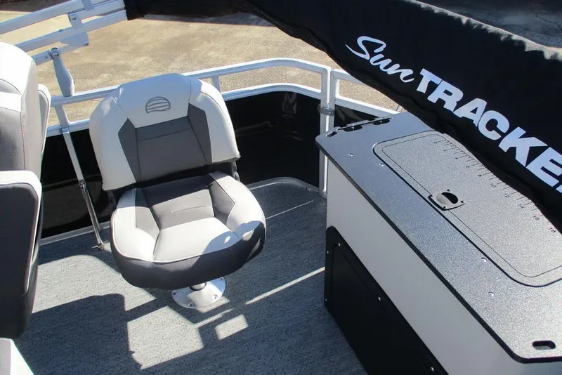 Slide: The Image of 2026 Sun Tracker Fishin' Barge 20 DLX interior with seating and storage. - 8