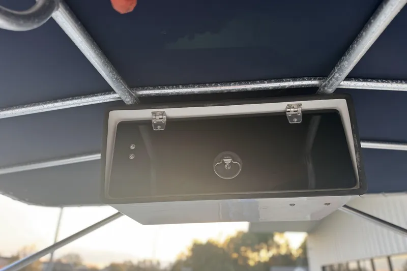 Slide: The Image of Storage compartment on a 2001 Grady-White Freedom 192 boat, under a canopy. - 13
