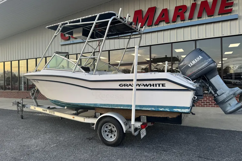 Slide: The Image of 2001 Grady-White Freedom 192 boat on trailer, parked outside marine store. - 2