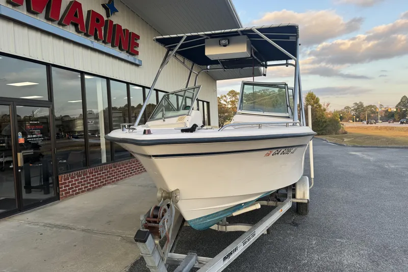 Slide: The Image of 2001 Grady-White Freedom 192 boat on trailer outside marine store. - 6