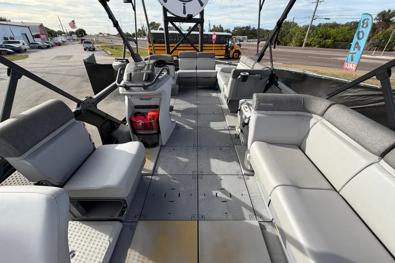 Slide: The Image of 2022 Sea-Doo Switch Sport 21 pontoon boat interior with seating and canopy. - 38