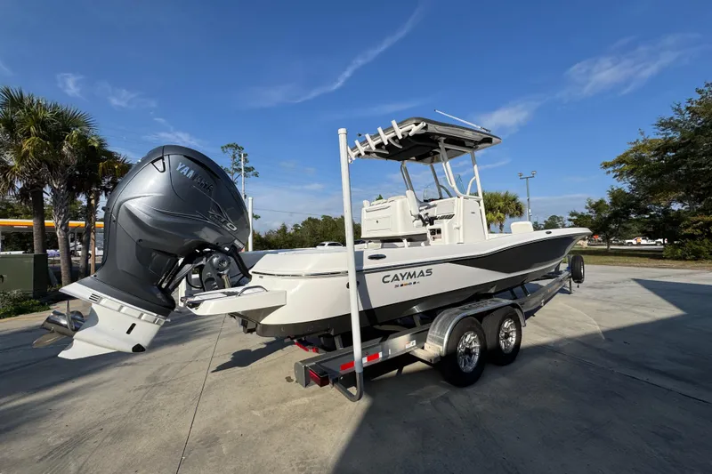 Slide: The Image of 2020 Caymas 28 HB boat on trailer with Yamaha outboard motor, parked outdoors. - 13
