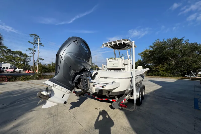 Slide: The Image of 2020 Caymas 28 HB boat with Yamaha outboard engine on trailer, parked outdoors. - 14