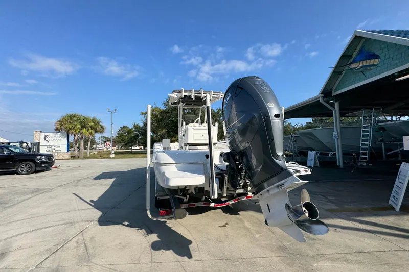 Slide: The Image of 2020 Caymas 28 HB boat with Yamaha outboard motor in a sunny marina setting. - 17