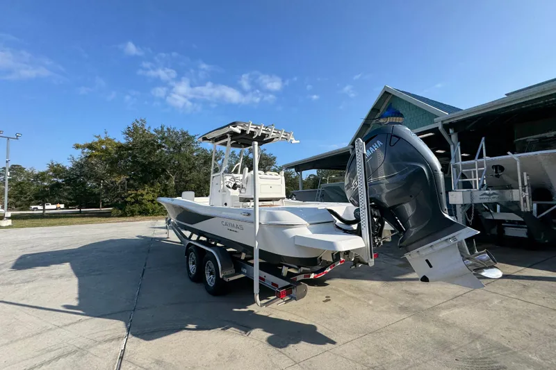 Slide: The Image of 2020 Caymas 28 HB boat on trailer with Yamaha outboard motor, parked outdoors. - 18
