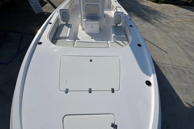 Slide: The Image of 2020 Caymas 28 HB boat deck with seating and storage compartments. - 22