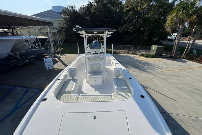 Slide: The Image of 2020 Caymas 28 HB boat with spacious deck, parked outdoors under clear sky. - 23