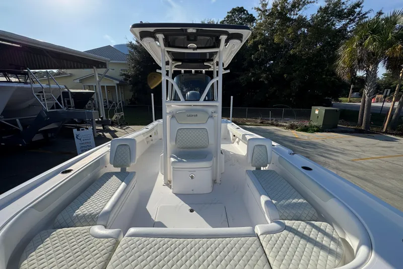 Slide: The Image of 2020 Caymas 28 HB boat with spacious seating and modern design in a sunny outdoor setting. - 24