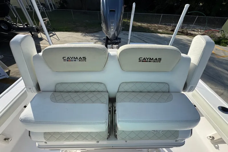 Slide: The Image of 2020 Caymas 28 HB boat seats with logo, featuring white cushioned design. - 28