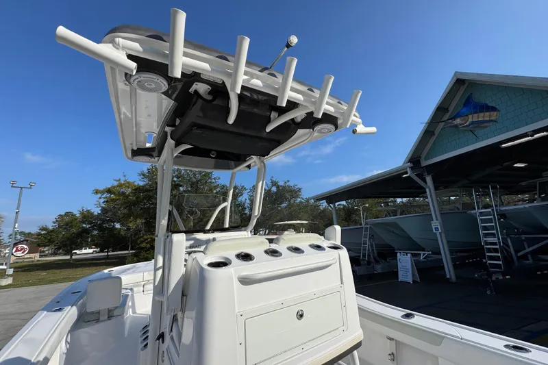 Slide: The Image of 2020 Caymas 28 HB boat with T-top and console, displayed outdoors under clear sky. - 37