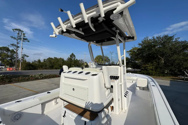 Slide: The Image of 2020 Caymas 28 HB boat with T-top and console, parked outdoors. - 38