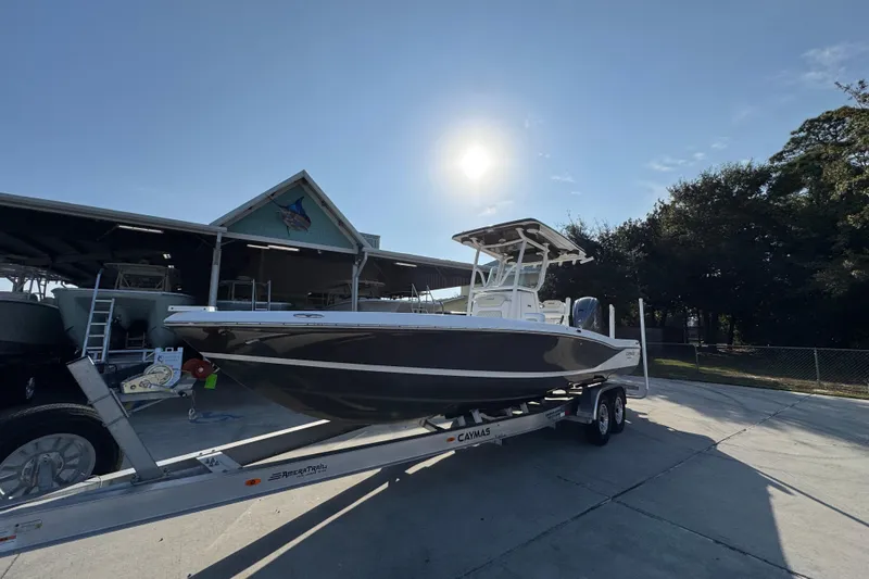 Slide: The Image of 2020 Caymas 28 HB boat on trailer under sunny sky near storage facility. - 4