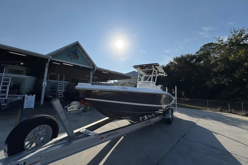 Slide: The Image of 2020 Caymas 28 HB boat on trailer under sunny sky near storage facility. - 5