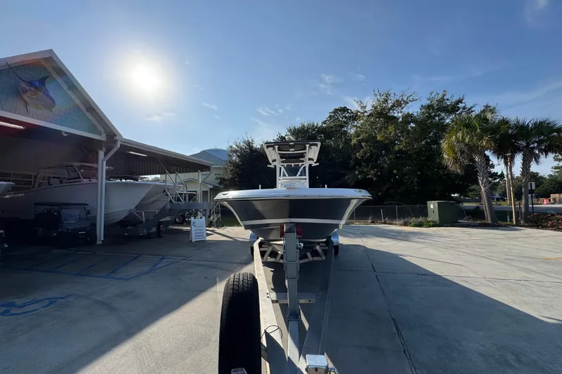 Slide: The Image of 2020 Caymas 28 HB boat on trailer under sunny sky near dealership. - 7