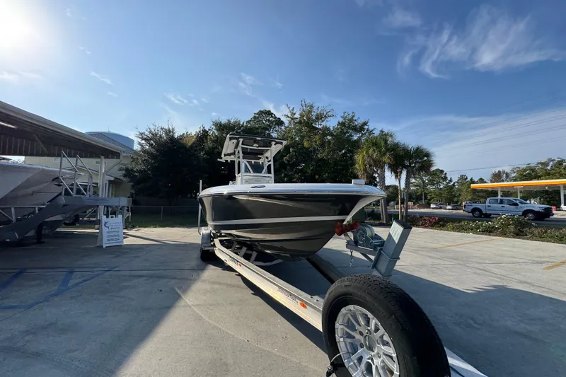 Slide: The Image of 2020 Caymas 28 HB boat on trailer under clear blue sky. - 8