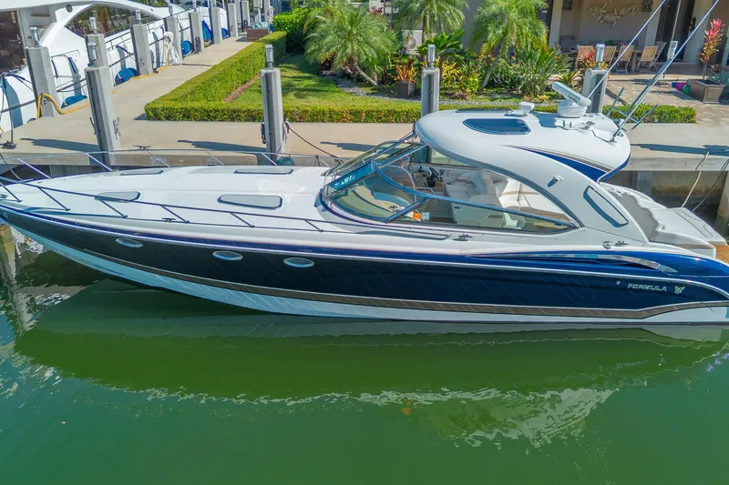 The Image of 2013 Formula 400 Super Sport yacht docked in a marina, surrounded by lush greenery. - 0